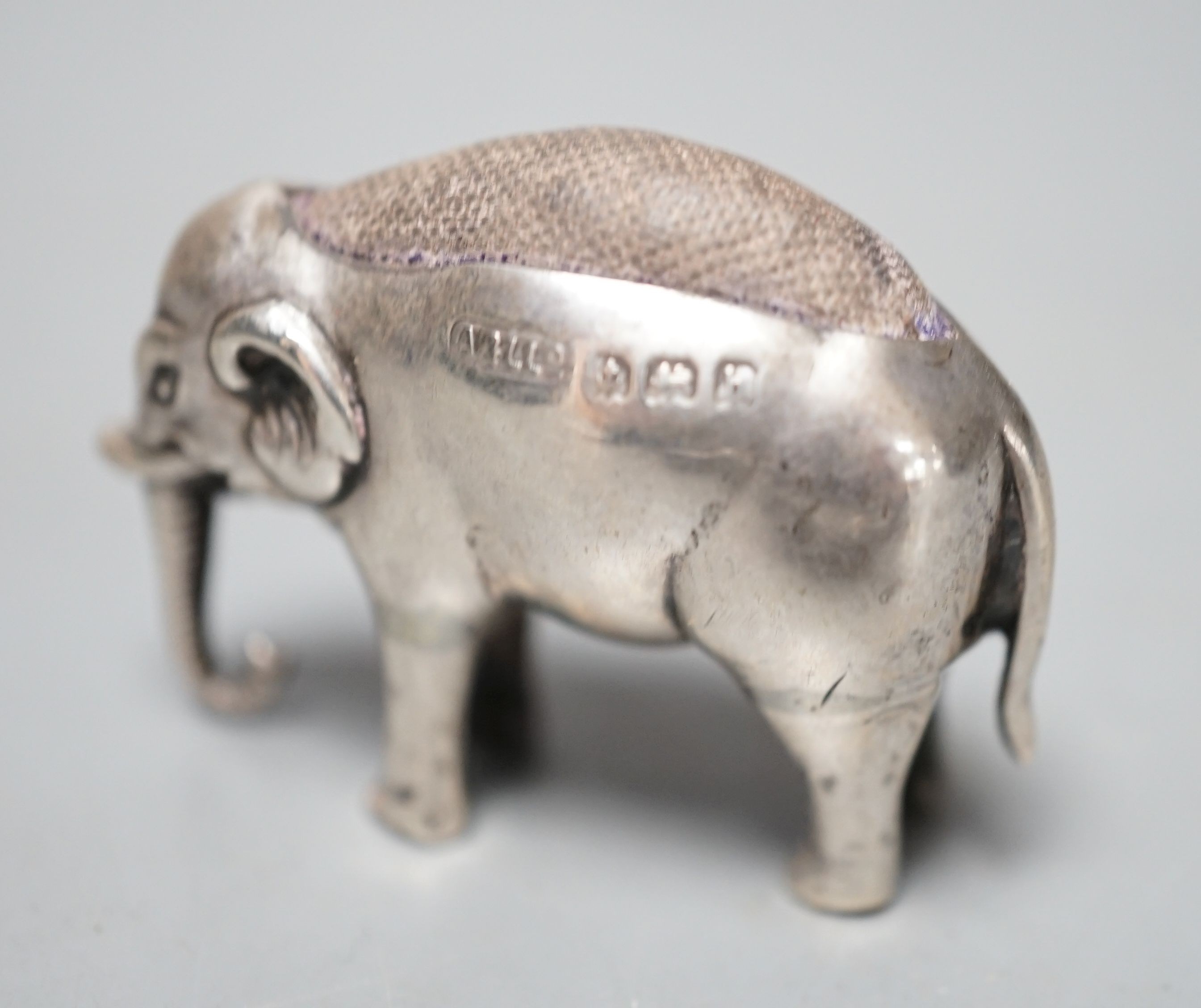 An Edwardian novelty silver elephant pin cushion, Adie & Lovekin Ltd, Birmingham, 1907, length 4cm.